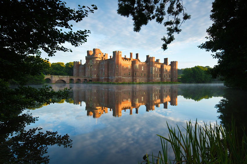 Castle taken from the trees, reflected onto the moat